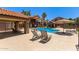 Community pool and deck area with chairs and a covered lounging area at 1905 E University Dr # 139, Tempe, AZ 85288