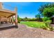 Expansive backyard featuring lush lawn, desert landscaping, and a sparkling pool, ideal for outdoor entertaining at 19415 W Colter St, Litchfield Park, AZ 85340