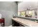Convenient wet bar area with granite countertops and dark gray painted walls at 19415 W Colter St, Litchfield Park, AZ 85340