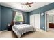 Cozy bedroom with carpet flooring, a ceiling fan, and natural lighting at 19415 W Colter St, Litchfield Park, AZ 85340