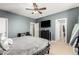 Bedroom showcasing a ceiling fan, television, and neutral colored walls at 19415 W Colter St, Litchfield Park, AZ 85340