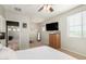 Bedroom featuring a bed, dresser, television and three windows at 19415 W Colter St, Litchfield Park, AZ 85340