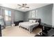 Comfortable bedroom featuring a ceiling fan, carpet flooring, and modern decor at 19415 W Colter St, Litchfield Park, AZ 85340