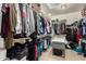 Large walk-in closet with clothing racks, shelves, and plenty of space for storage at 19415 W Colter St, Litchfield Park, AZ 85340