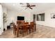 Cozy dining room with wood table, six chairs, and a view of the living room at 19415 W Colter St, Litchfield Park, AZ 85340