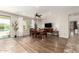 Well-lit dining room with modern wood flooring, ceiling fan, and view of the backyard at 19415 W Colter St, Litchfield Park, AZ 85340