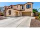 Charming two-story house showcasing a three-car garage, a spacious driveway, and well-kept landscaping at 19415 W Colter St, Litchfield Park, AZ 85340