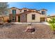 Beautiful two-story home featuring a low maintenance desert rock front yard and a charming desert landscape at 19415 W Colter St, Litchfield Park, AZ 85340