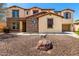 Charming home with a stone facade, desert landscaping, and a well-maintained yard, offering inviting curb appeal at 19415 W Colter St, Litchfield Park, AZ 85340