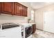 Clean laundry room featuring lots of cabinet storage and modern appliances at 19415 W Colter St, Litchfield Park, AZ 85340