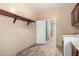 Spacious laundry room with lots of storage and tile flooring at 19415 W Colter St, Litchfield Park, AZ 85340