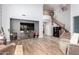 Light-filled living room featuring a media center, tile flooring, and staircase leading to the second floor at 19415 W Colter St, Litchfield Park, AZ 85340