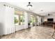 Bright and spacious living area featuring tile flooring, large windows, and serene views of the backyard at 19415 W Colter St, Litchfield Park, AZ 85340