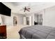 Large main bedroom with a ceiling fan, gray walls and carpet, and a door to the balcony at 19415 W Colter St, Litchfield Park, AZ 85340