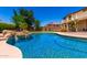 The pool is surrounded by lush greenery, providing a tranquil and inviting atmosphere for leisure and recreation at 19415 W Colter St, Litchfield Park, AZ 85340