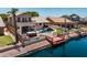 Stunning aerial view showcasing the home's outdoor space, including the pool, hot tub, and private dock on the water at 20657 N 56Th Ave, Glendale, AZ 85308