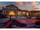 Multi-level backyard featuring a pool, hot tub, patio area, and a unique staircase at twilight at 20657 N 56Th Ave, Glendale, AZ 85308