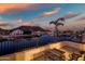 Balcony seating area that overlooks a waterfront and residential properties, set against a colorful sky at 20657 N 56Th Ave, Glendale, AZ 85308