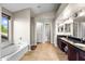 Spacious bathroom featuring dual vanities and a luxurious soaking tub at 20657 N 56Th Ave, Glendale, AZ 85308
