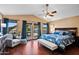 Inviting bedroom with ceiling fan, french doors to a balcony, and luxury vinyl flooring, perfect for relaxation at 20657 N 56Th Ave, Glendale, AZ 85308