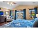 Spacious bedroom with natural lighting, comfortable seating, french door access to a balcony, and luxury vinyl flooring at 20657 N 56Th Ave, Glendale, AZ 85308
