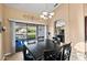 Dining area with a table, chairs, and sliding doors to an outdoor view of the waterway at 20657 N 56Th Ave, Glendale, AZ 85308
