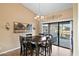 Dining room featuring tile flooring, a decorative chandelier, and access to outdoor scenery at 20657 N 56Th Ave, Glendale, AZ 85308