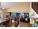 A dining room with stairway to the lower level and view into the living room at 20657 N 56Th Ave, Glendale, AZ 85308