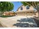 Traditional two-story home featuring a three-car garage and mature landscaping at 20657 N 56Th Ave, Glendale, AZ 85308