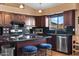 A kitchen featuring dark wood cabinets, granite countertops, and stainless steel appliances at 20657 N 56Th Ave, Glendale, AZ 85308