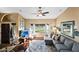 Cozy living room with hardwood floors, ceiling fan, and an abundance of natural light at 20657 N 56Th Ave, Glendale, AZ 85308