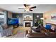Living room with fireplace, mounted TV, and leather furniture, showcasing a cozy and inviting atmosphere at 20657 N 56Th Ave, Glendale, AZ 85308