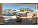 Charming outdoor patio with a waterfront view, showcasing a hot tub and a cozy fireplace, ideal for relaxation at 20657 N 56Th Ave, Glendale, AZ 85308