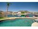 Backyard pool and lake view surrounded by lush landscaping at 20657 N 56Th Ave, Glendale, AZ 85308