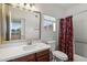 Bathroom featuring a vanity, a mirror, a toilet and a tub-shower combo with colorful shower curtain at 2134 E Broadway Rd # 2031, Tempe, AZ 85282