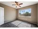 Bedroom with neutral walls, carpet, window with views, and ceiling fan at 2134 E Broadway Rd # 2031, Tempe, AZ 85282