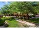 Exterior view of community with walkways, grass, landscaping, and trees at 2134 E Broadway Rd # 2031, Tempe, AZ 85282