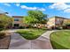 Exterior of property with walkways, grass, and mature tree at 2134 E Broadway Rd # 2031, Tempe, AZ 85282