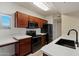 Stylish kitchen featuring dark appliances, wood cabinetry and modern countertops at 2134 E Broadway Rd # 2031, Tempe, AZ 85282