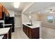 Contemporary kitchen featuring dark wood cabinets, stainless appliances, and an open layout at 2134 E Broadway Rd # 2031, Tempe, AZ 85282