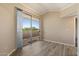 Living room showcasing sliding glass door to balcony, neutral paint, and wood-look flooring at 2134 E Broadway Rd # 2031, Tempe, AZ 85282