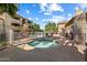 Community pool area with hot tub, lounge chairs, and palm trees at 2134 E Broadway Rd # 2031, Tempe, AZ 85282