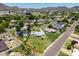 Aerial view showcases fenced property in a residential neighborhood with mature trees, and mountain views at 215 W Ruth Ave, Phoenix, AZ 85021