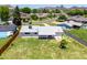 Aerial backyard view of the property with covered patio, green grass and wood fence at 215 W Ruth Ave, Phoenix, AZ 85021