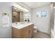 Bright bathroom featuring a wood vanity, modern mirror, and stylish gold accents at 215 W Ruth Ave, Phoenix, AZ 85021