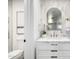 Elegant bathroom boasts modern vanity, marble countertop, and a stylish oval mirror at 215 W Ruth Ave, Phoenix, AZ 85021