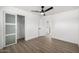 Bedroom with a modern ceiling fan, wood-look flooring, and a closet with frosted glass doors at 215 W Ruth Ave, Phoenix, AZ 85021