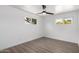 Light-filled bedroom featuring wood-look floors, white walls, and dual windows for ample light at 215 W Ruth Ave, Phoenix, AZ 85021