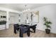 Elegant dining room with modern chandelier, glass table, and stylish black chairs at 215 W Ruth Ave, Phoenix, AZ 85021