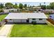 Charming home with lush green lawn, a large front porch, and mature trees at 215 W Ruth Ave, Phoenix, AZ 85021